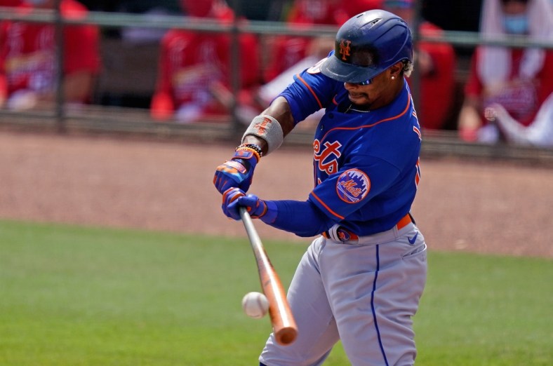 Mar 29, 2021; Jupiter, Florida, USA; New York Mets shortstop Francisco Lindor (12) doubles in the 1st inning of the spring training game against the St. Louis Cardinals at Roger Dean Chevrolet Stadium. Mandatory Credit: Jasen Vinlove-USA TODAY Sports