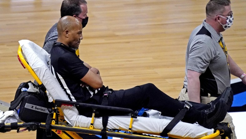 Mar 30, 2021; Indianapolis, IN, USA; A NCAA referee is helped off the court after falling on the court during the game between the Gonzaga Bulldogs and the USC Trojans in the Elite Eight of the 2021 NCAA Tournament at Lucas Oil Stadium. Mandatory Credit: Robert Deutsch-USA TODAY Sports