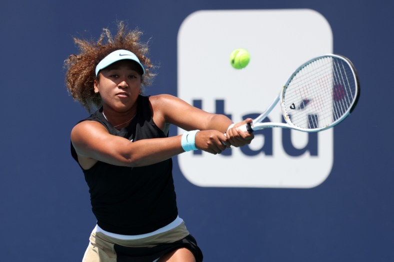 Mar 31, 2021; Miami, Florida, USA; Naomi Osaka of Japan hits a backhand against Maria Sakkari of Greece (not pictured) in a women's singles quarterfinal in the Miami Open at Hard Rock Stadium. Mandatory Credit: Geoff Burke-USA TODAY Sports