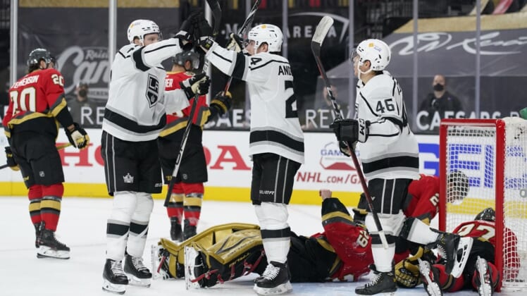 Mar 31, 2021; Las Vegas, Nevada, USA;  Los Angeles Kings    Lias Andersson, center, celebrates after scoring against Vegas Golden Knights goaltender Marc-Andre Fleury during the first period at T-Mobile Arena. Mandatory Credit:  John Locher/POOL PHOTOS-USA TODAY Sports