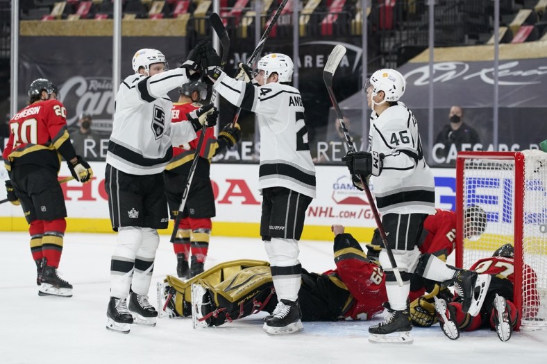 Mar 31, 2021; Las Vegas, Nevada, USA;  Los Angeles Kings    Lias Andersson, center, celebrates after scoring against Vegas Golden Knights goaltender Marc-Andre Fleury during the first period at T-Mobile Arena. Mandatory Credit:  John Locher/POOL PHOTOS-USA TODAY Sports
