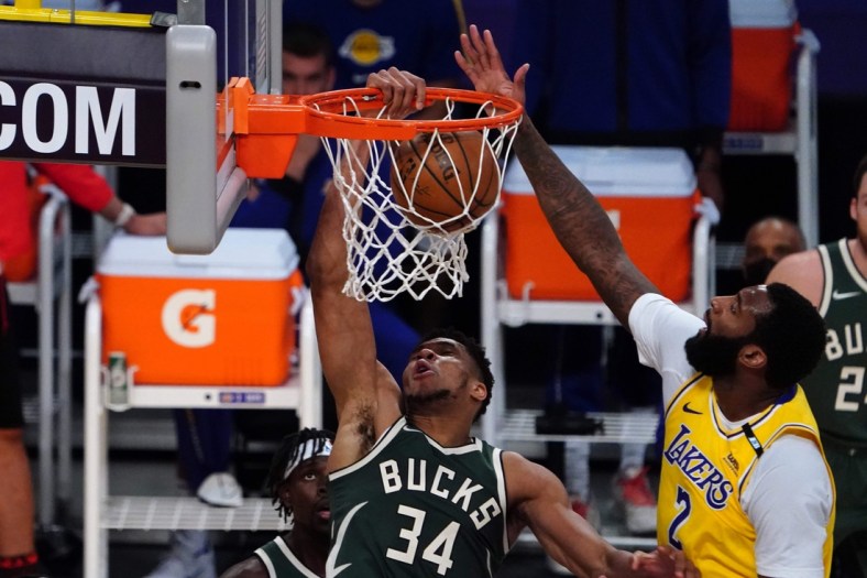 Mar 31, 2021; Los Angeles, California, USA; Milwaukee Bucks forward Giannis Antetokounmpo (34) dunks the ball against Los Angeles Lakers center Andre Drummond (2) during the first half at Staples Center. Mandatory Credit: Kirby Lee-USA TODAY Sports