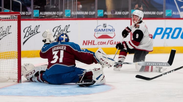 Mar 31, 2021; Denver, Colorado, USA; Colorado Avalanche goaltender Philipp Grubauer (31) makes a save on a shot from Arizona Coyotes right wing Clayton Keller (9) in the second period at Ball Arena. Mandatory Credit: Isaiah J. Downing-USA TODAY Sports
