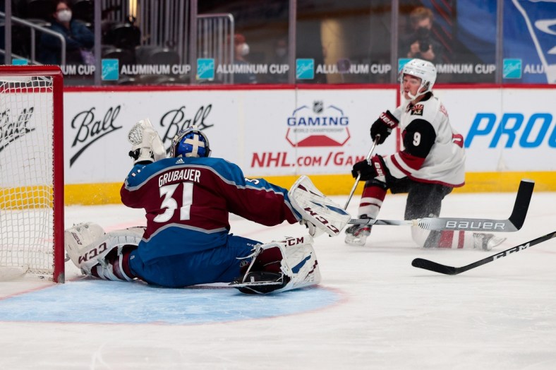 Mar 31, 2021; Denver, Colorado, USA; Colorado Avalanche goaltender Philipp Grubauer (31) makes a save on a shot from Arizona Coyotes right wing Clayton Keller (9) in the second period at Ball Arena. Mandatory Credit: Isaiah J. Downing-USA TODAY Sports