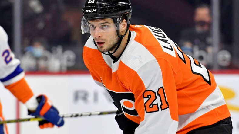 Mar 22, 2021; Philadelphia, Pennsylvania, USA; Philadelphia Flyers left wing Scott Laughton (21) against the New York Islanders at Wells Fargo Center. Mandatory Credit: Eric Hartline-USA TODAY Sports