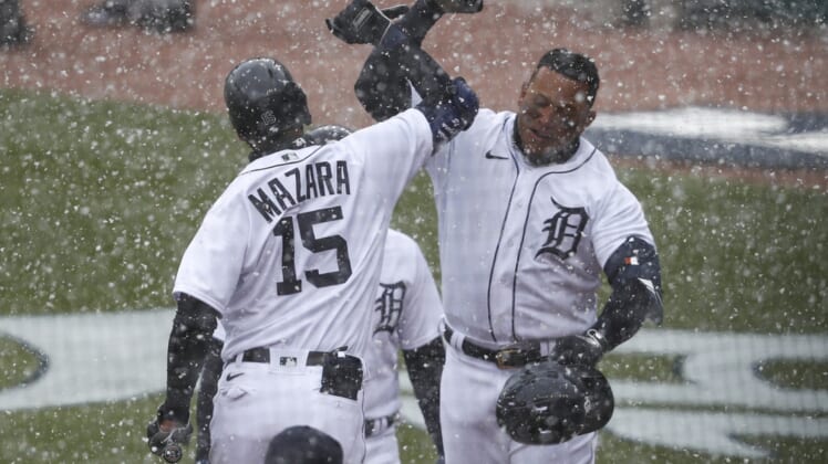 Apr 1, 2021; Detroit, Michigan, USA; Detroit Tigers first baseman Miguel Cabrera (24) celebrates with designated hitter Nomar Mazara (15) in the snow after hitting a two run home run during the first inning against the Cleveland Indians on Opening Day at Comerica Park. Mandatory Credit: Raj Mehta-USA TODAY Sports