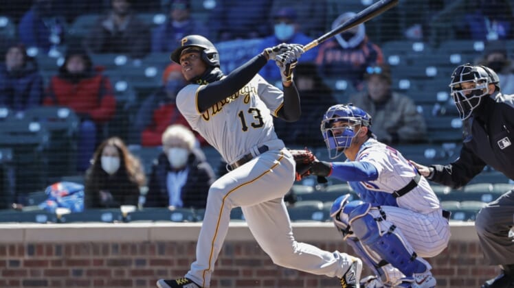 Apr 1, 2021; Chicago, Illinois, USA; Pittsburgh Pirates third baseman Ke'Bryan Hayes (13) hits a two-run home run against the Chicago Cubs in the first inning at Wrigley Field. Mandatory Credit: Kamil Krzaczynski-USA TODAY Sports