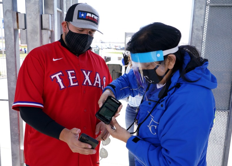Apr 1, 2021; Kansas City, Missouri, USA; A Texas Rangers fan is scanned into the park via contactless scanners before the Opening Day game against the Texas Rangers at Kauffman Stadium. Mandatory Credit: Denny Medley-USA TODAY Sports