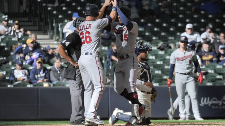 Apr 1, 2021; Milwaukee, Wisconsin, USA; Minnesota Twins center fielder Byron Buxton (25) is congratulated by teammate Max Kepler (26) after hitting a home run in the seventh inning against the Milwaukee Brewers at American Family Field. Mandatory Credit: Michael McLoone-USA TODAY Sports