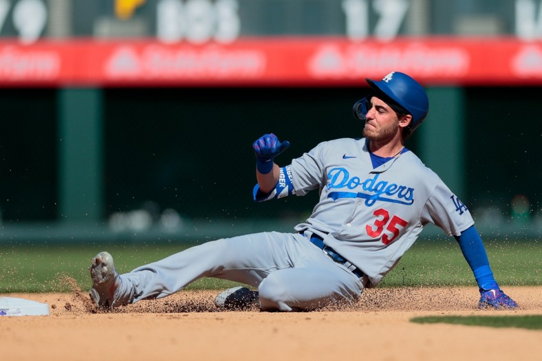 Apr 1, 2021; Denver, Colorado, USA; Los Angeles Dodgers center fielder Cody Bellinger (35) slides safely in to second on a double in the fifth inning against the Colorado Rockies at Coors Field. Mandatory Credit: Isaiah J. Downing-USA TODAY Sports