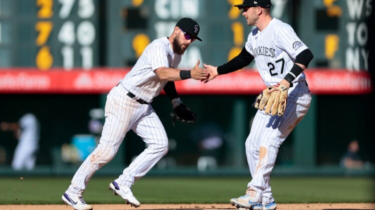 Apr 1, 2021; Denver, Colorado, USA; Colorado Rockies second baseman Chris Owings (12) celebrates with shortstop Trevor Story (27) after turning a double play in the seventh inning against the Los Angeles Dodgers at Coors Field. Mandatory Credit: Isaiah J. Downing-USA TODAY Sports