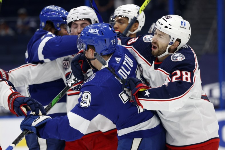 Apr 1, 2021; Tampa, Florida, USA; Columbus Blue Jackets right wing Oliver Bjorkstrand (28) and Tampa Bay Lightning left wing Ross Colton (79) and teammates defend each other during the first period at Amalie Arena. Mandatory Credit: Kim Klement-USA TODAY Sports