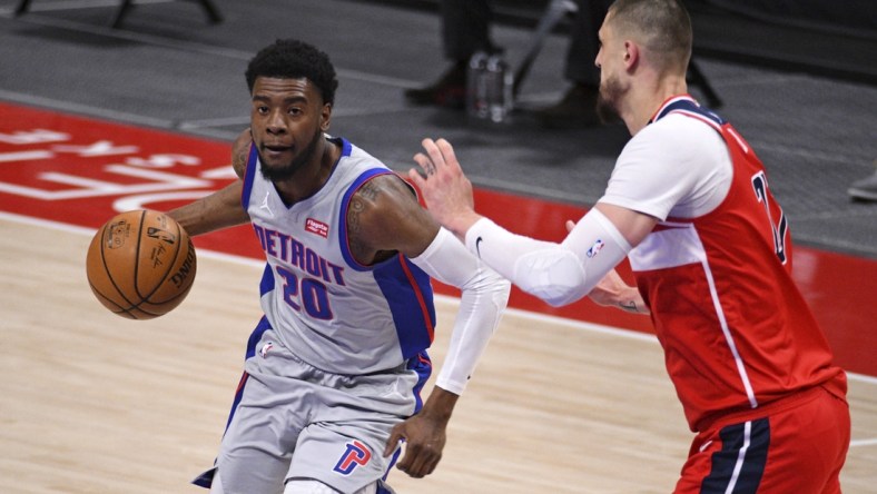 Apr 1, 2021; Detroit, Michigan, USA; Detroit Pistons guard Josh Jackson (20) drives to the basket as Washington Wizards center Alex Len (27) defends during the first quarter at Little Caesars Arena. Mandatory Credit: Tim Fuller-USA TODAY Sports