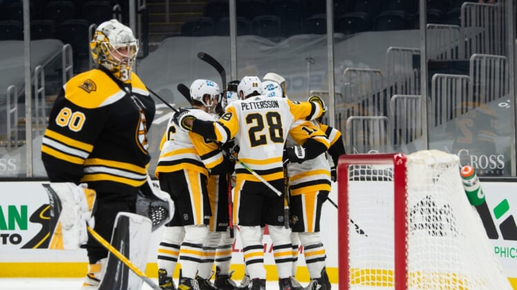 Apr 1, 2021; Boston, Massachusetts, USA; Pittsburgh Penguins defenseman Marcus Pettrsson (28) celebrates with teammates after Zach Aston-Reese (12) scored a goal against the Boston Bruins in the second period at TD Garden. Mandatory Credit: Kathryn Riley-USA TODAY Sports