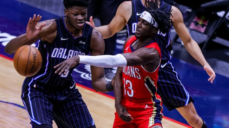 Apr 1, 2021; New Orleans, Louisiana, USA; New Orleans Pelicans guard Kira Lewis Jr. (13) passes the ball against Orlando Magic forward Chuma Okeke (3) during the first half at the Smoothie King Center. Mandatory Credit: Stephen Lew-USA TODAY Sports