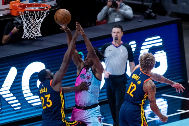 Apr 1, 2021; Miami, Florida, USA; Miami Heat forward Jimmy Butler (22) passes the ball over Golden State Warriors forward Draymond Green (23) during the second quarter of a game at American Airlines Arena. Mandatory Credit: Mary Holt-USA TODAY Sports