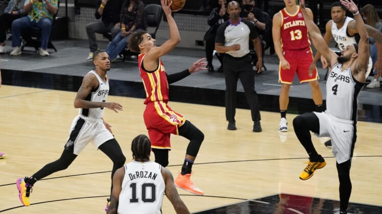 Apr 1, 2021; San Antonio, Texas, USA; Atlanta Hawks guard Trae Young (11) attempts the final shot of the fourth quarter for the win over San Antonio Spurs guard Derrick White (4) at AT&T Center. Mandatory Credit: Scott Wachter-USA TODAY Sports
