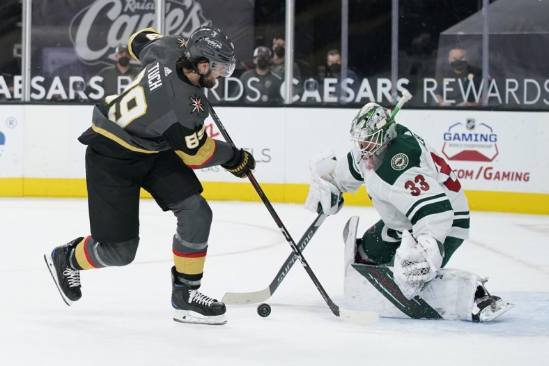 Apr 1, 2021; Las Vegas, Nevada, USA; Minnesota Wild goaltender Cam Talbot (33) blocks a shot by Vegas Golden Knights right wing Alex Tuch (89) during the second period at T-Mobile Arena. Mandatory Credit: John Locher/The Associated Press via USA TODAY Network )