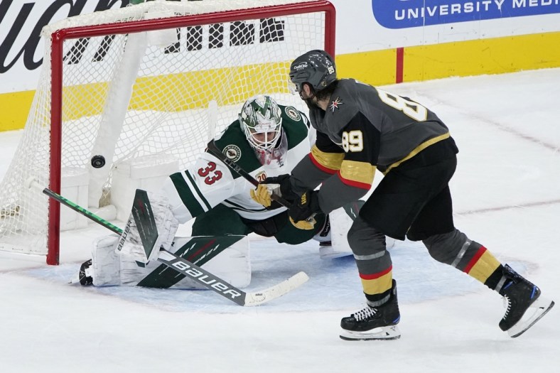 Apr 1, 2021; Las Vegas, Nevada, USA; Vegas Golden Knights right wing Alex Tuch (89) misses a shot on Minnesota Wild goaltender Cam Talbot (33) in a shootout  at T-Mobile Arena. Mandatory Credit: John Locher/The Associated Press via USA TODAY Network )