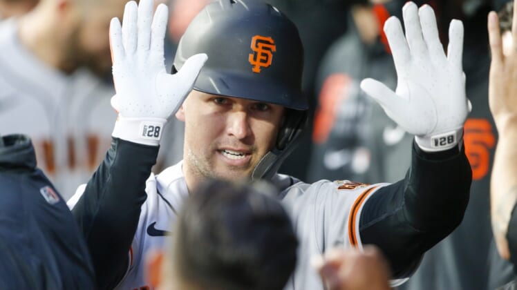 Apr 1, 2021; Seattle, Washington, USA; San Francisco Giants catcher Buster Posey (28) celebrates in the dugout after hitting a solo-home run against the Seattle Mariners during the second inning at T-Mobile Park. Mandatory Credit: Joe Nicholson-USA TODAY Sports