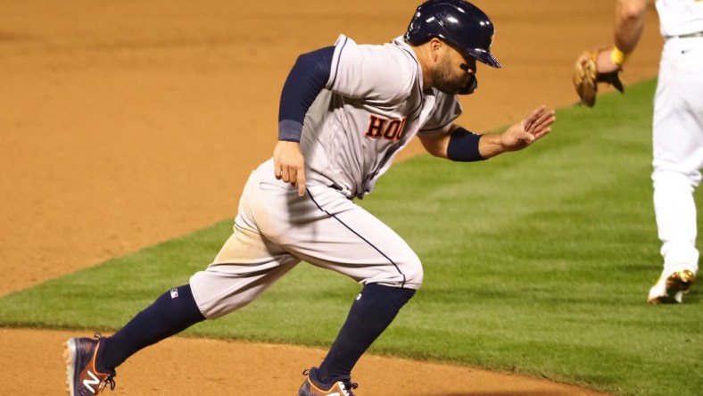 Apr 1, 2021; Oakland, California, USA; Houston Astros second baseman Jose Altuve (27) scores a run on a ground out against the Oakland Athletics during the ninth inning at RingCentral Coliseum. Mandatory Credit: Kelley L Cox-USA TODAY Sports