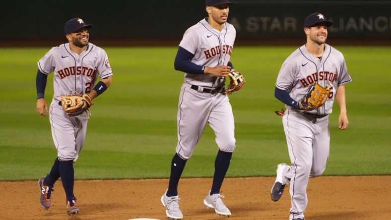 Apr 1, 2021; Oakland, California, USA; Houston Astros second baseman Jose Altuve (27), shortstop Carlos Correa (1) and left fielder Chas McCormick (6) celebrate after a win against the Oakland Athletics at RingCentral Coliseum. Mandatory Credit: Kelley L Cox-USA TODAY Sports