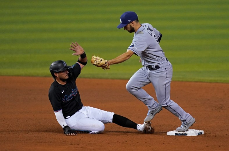 Apr 2, 2021; Miami, Florida, USA; Tampa Bay Rays second baseman Brandon Lowe (8) doubles off Miami Marlins shortstop Miguel Rojas (19) in the 4th inning at loanDepot park. Mandatory Credit: Jasen Vinlove-USA TODAY Sports