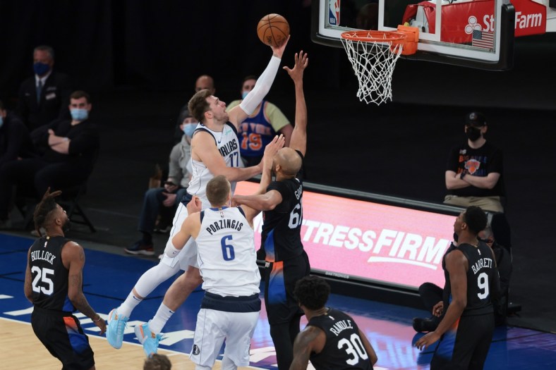 Apr 2, 2021; New York, New York, USA; Dallas Mavericks guard Luka Doncic (77) drives to the basket against New York Knicks center Taj Gibson (67) during the second half at Madison Square Garden. Mandatory Credit: Vincent Carchietta-USA TODAY Sports