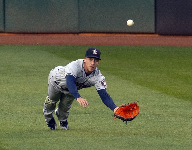 Apr 2, 2021; Oakland, California, USA; Houston Astros center fielder Myles Straw (3) makes a diving catch of a line drive off the bat of Oakland Athletics hitter Ram n Laureano during the first inning of a Major League Baseball game at RingCentral Coliseum. Mandatory Credit: D. Ross Cameron-USA TODAY Sports