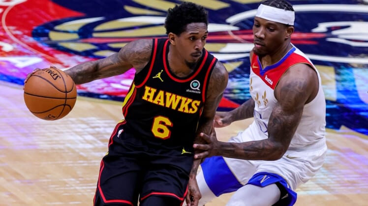 Apr 2, 2021; New Orleans, Louisiana, USA;  Atlanta Hawks guard Lou Williams (6) dribbles around New Orleans Pelicans guard Eric Bledsoe (5) during the first half at the Smoothie King Center. Mandatory Credit: Stephen Lew-USA TODAY Sports