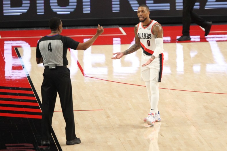 Apr 2, 2021; Portland, Oregon, USA;  Portland Trail Blazers guard Damian Lillard (0) pleads his case to referee Sean Wright (4) after being called for a foul in the first half at Moda Center. Mandatory Credit: Jaime Valdez-USA TODAY Sports