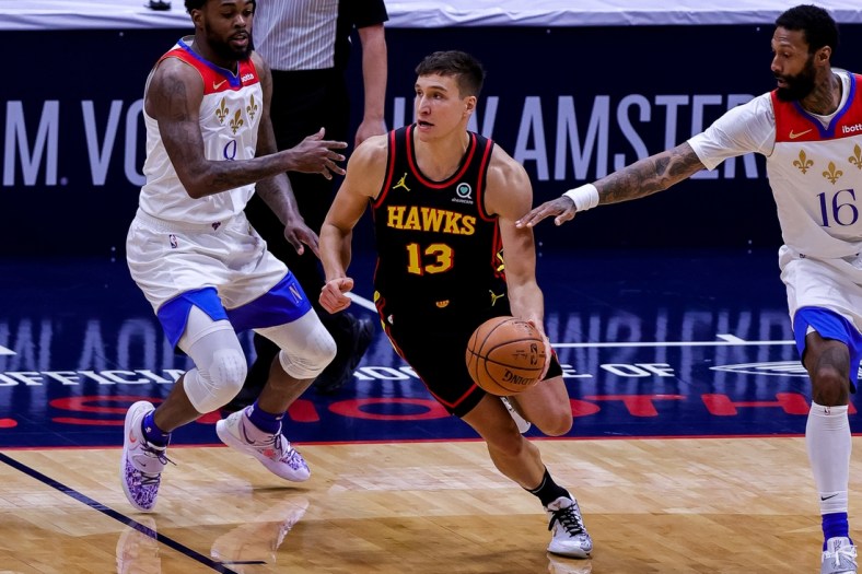 Apr 2, 2021; New Orleans, Louisiana, USA;  Atlanta Hawks guard Bogdan Bogdanovic (13) dribbles against New Orleans Pelicans forward James Johnson (16) during the second half at the Smoothie King Center. Mandatory Credit: Stephen Lew-USA TODAY Sports