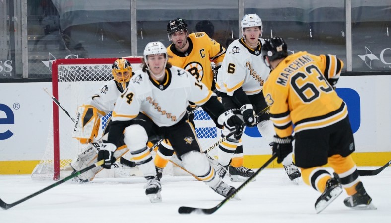 Apr 3, 2021; Boston, Massachusetts, USA; Boston Bruins center Brad Marchand (63) shoots on goal against the Pittsburgh Penguins in the second period at TD Garden. Mandatory Credit: David Butler II-USA TODAY Sports