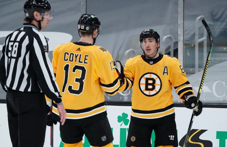 Apr 3, 2021; Boston, Massachusetts, USA; Boston Bruins center Brad Marchand (63) is congratulated by center Charlie Coyle (13) after scoring his third goal of the game against the Pittsburgh Penguins in the third period at TD Garden. Mandatory Credit: David Butler II-USA TODAY Sports