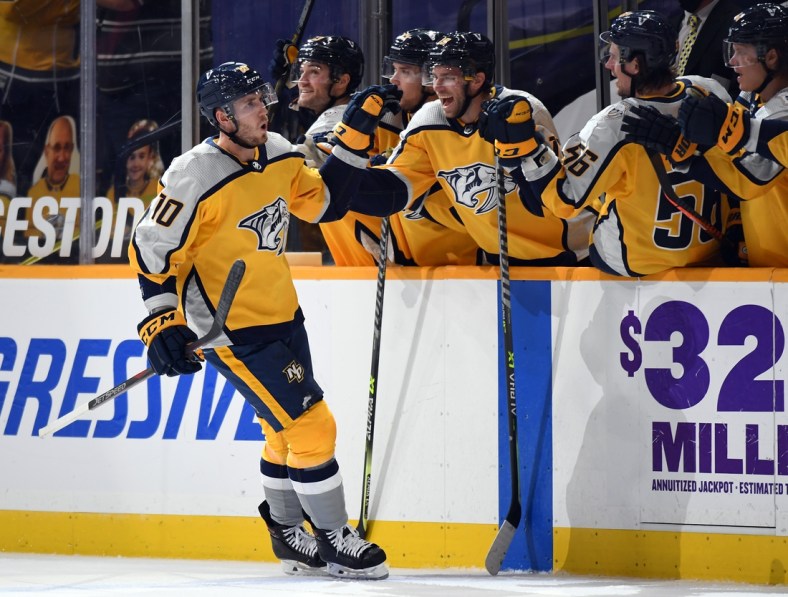 Apr 3, 2021; Nashville, Tennessee, USA; Nashville Predators center Colton Sissons (10) celebrates with teammates after scoring on a penalty shot during the second period against the Chicago Blackhawks at Bridgestone Arena. Mandatory Credit: Christopher Hanewinckel-USA TODAY Sports