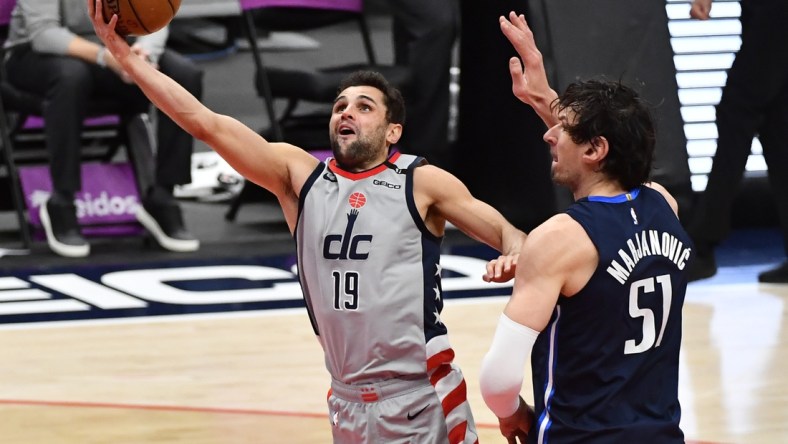 Apr 3, 2021; Washington, District of Columbia, USA; Washington Wizards guard Raul Neto (19) shoots past Dallas Mavericks center Boban Marjanovic (51) during the second quarter at Capital One Arena. Mandatory Credit: Brad Mills-USA TODAY Sports