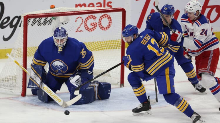 Apr 3, 2021; Buffalo, New York, USA;  Buffalo Sabres goaltender Linus Ullmark (35) makes a save as center Tobias Rieder (13) moves to clear the puck against the New York Rangers during the second period at KeyBank Center. Mandatory Credit: Timothy T. Ludwig-USA TODAY Sports
