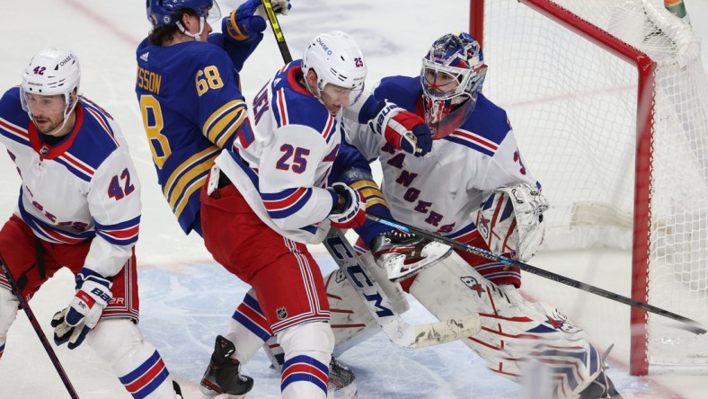 Apr 3, 2021; Buffalo, New York, USA;  New York Rangers defenseman Libor Hajek (25) knocks down Buffalo Sabres right wing Victor Olofsson (68) as New York goaltender Igor Shesterkin (31) looks for the puck during the second period at KeyBank Center. Mandatory Credit: Timothy T. Ludwig-USA TODAY Sports