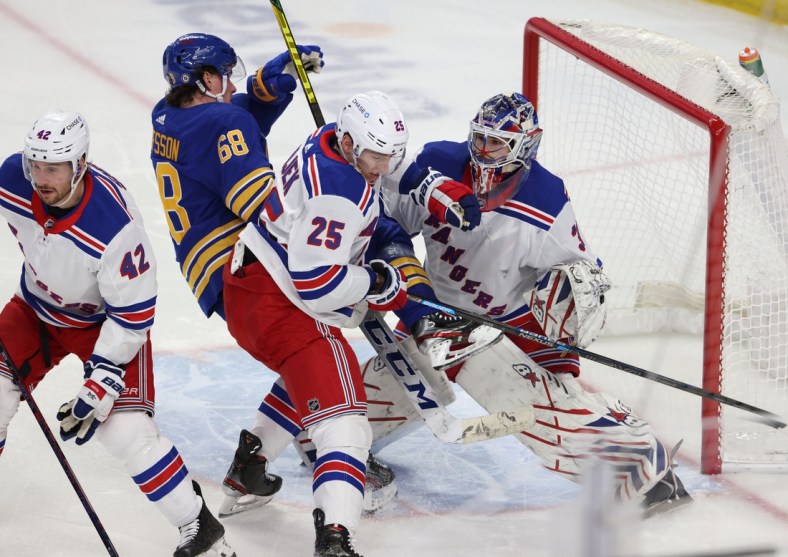 Apr 3, 2021; Buffalo, New York, USA;  New York Rangers defenseman Libor Hajek (25) knocks down Buffalo Sabres right wing Victor Olofsson (68) as New York goaltender Igor Shesterkin (31) looks for the puck during the second period at KeyBank Center. Mandatory Credit: Timothy T. Ludwig-USA TODAY Sports