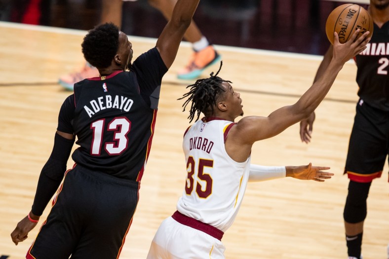 Apr 3, 2021; Miami, Florida, USA; Cleveland Cavaliers forward Isaac Okoro (35) attempts a layup past Miami Heat center Bam Adebayo (13) during the second quarter of a game at American Airlines Arena. Mandatory Credit: Mary Holt-USA TODAY Sports