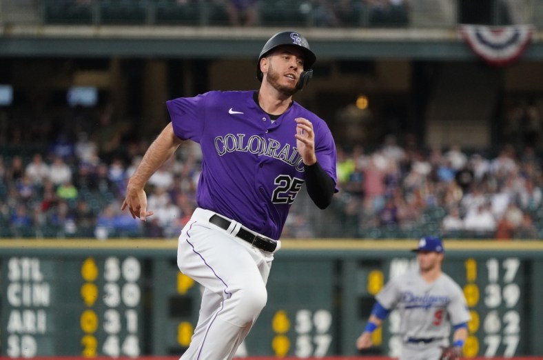 Apr 3, 2021; Denver, Colorado, USA;  Colorado Rockies first baseman C.J. Cron (25) heads in to score a run against the Los Angeles Dodgers in the fourth inning at Coors Field. Mandatory Credit: Ron Chenoy-USA TODAY Sports