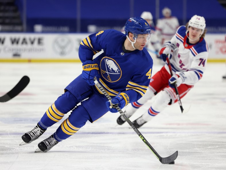 Apr 3, 2021; Buffalo, New York, USA;  Buffalo Sabres left wing Taylor Hall (4) skates with the puck against the New York Rangers during the third period at KeyBank Center. Mandatory Credit: Timothy T. Ludwig-USA TODAY Sports