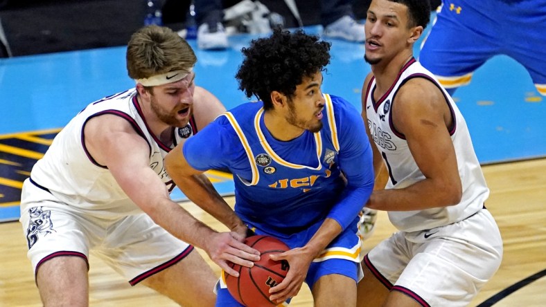Apr 3, 2021; Indianapolis, Indiana, USA; UCLA Bruins guard Johnny Juzang (3) handles the ball against Gonzaga Bulldogs forward Drew Timme (2) and guard Jalen Suggs (1) during the second half in the national semifinals of the Final Four of the 2021 NCAA Tournament at Lucas Oil Stadium. Mandatory Credit: Robert Deutsch-USA TODAY Sports