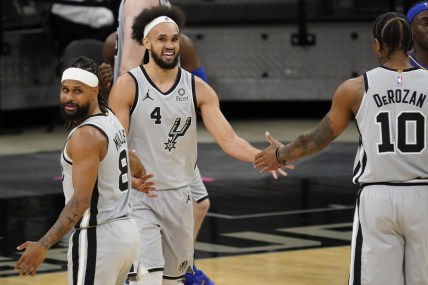 Apr 3, 2021; San Antonio, Texas, USA; San Antonio Spurs guard Derrick White (4) congraluated by guard Patty Mills (8) and forward DeMar DeRozan (10) after scoring and drawing foul in the third quarter of the game agains the Indiana Pacers at AT&T Center. Mandatory Credit: Scott Wachter-USA TODAY Sports