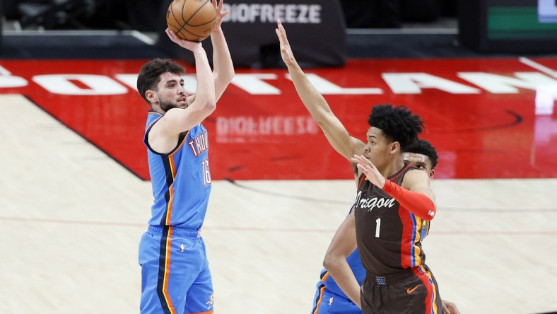 Apr 3, 2021; Portland, Oregon, USA; Oklahoma City Thunder shooting guard Ty Jerome (16) shoots the ball over Portland Trail Blazers shooting guard Anfernee Simons (1) during the first half at Moda Center. Mandatory Credit: Soobum Im-USA TODAY Sports