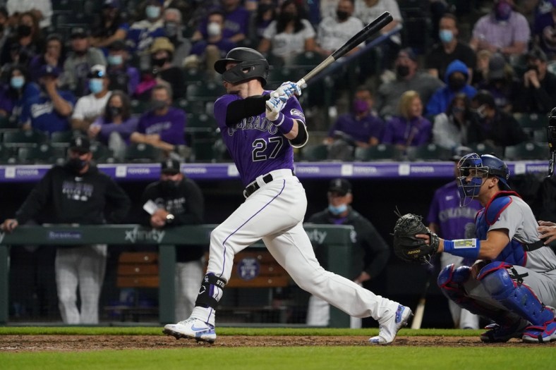 Apr 3, 2021; Denver, Colorado, USA; Colorado Rockies shortstop Trevor Story (27) hits a RBI double against the Los Angeles Dodgers in the eighth inning at Coors Field. Mandatory Credit: Ron Chenoy-USA TODAY Sports
