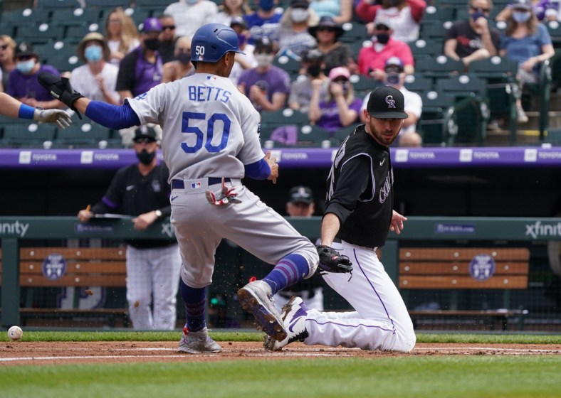 Apr 4, 2021; Denver, Colorado, USA; Los Angeles Dodgers right fielder Mookie Betts (50) scores on Colorado Rockies starting pitcher Austin Gomber (26) in the first inning at Coors Field. Mandatory Credit: Ron Chenoy-USA TODAY Sports