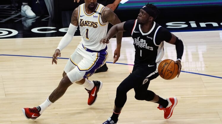 Apr 4, 2021; Los Angeles, California, USA; Los Angeles Clippers guard Reggie Jackson (1) moves to the basket against Los Angeles Lakers guard Kentavious Caldwell-Pope (1) during the first half at Staples Center. Mandatory Credit: Gary A. Vasquez-USA TODAY Sports