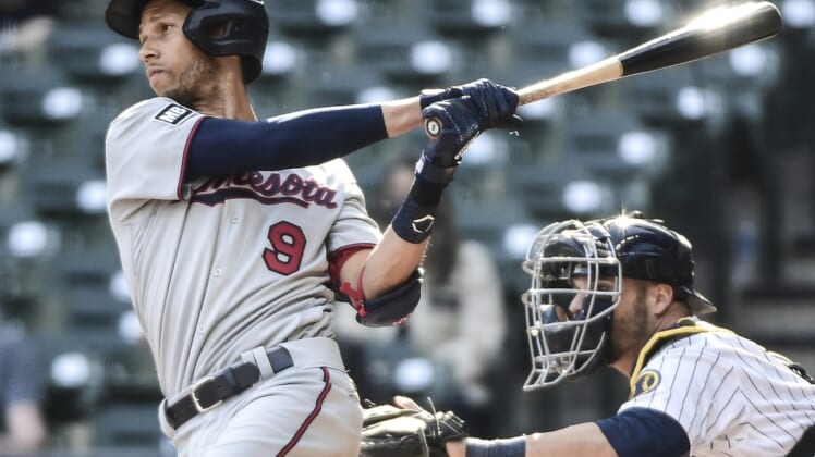 Apr 4, 2021; Milwaukee, Wisconsin, USA; Minnesota Twins shortstop Andrelton Simmons (9) hits a triple to drive in a run in the eighth inning against the Milwaukee Brewers at American Family Field. Mandatory Credit: Benny Sieu-USA TODAY Sports