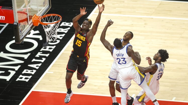 Apr 4, 2021; Atlanta, Georgia, USA; Atlanta Hawks center Clint Capela (15) goes up for an alley oop in front of Golden State Warriors forward Andrew Wiggins (22) and forward Draymond Green (23) and center James Wiseman (33) in the first quarter at State Farm Arena. Mandatory Credit: Brett Davis-USA TODAY Sports